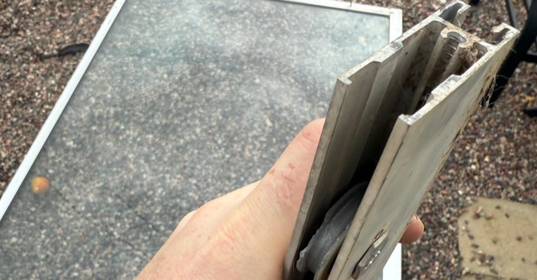 Close-up of a sliding patio door lower track