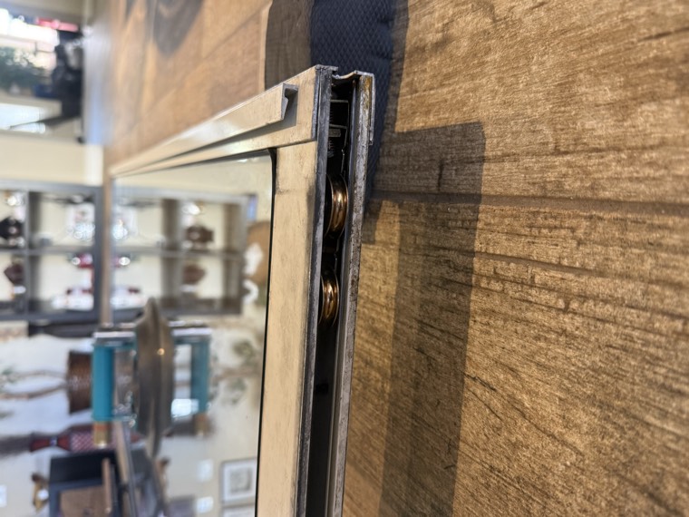 Sliding door panel bottom with the roller assembly visible