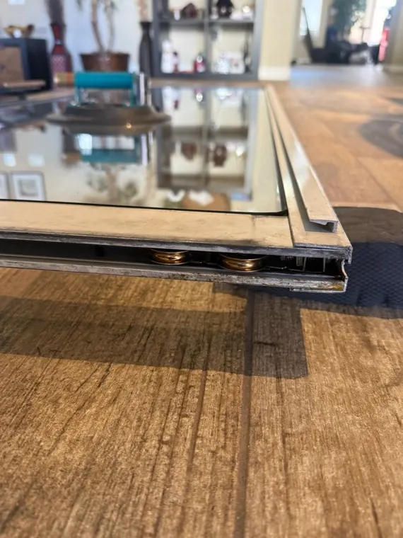 Sliding door panel bottom with the roller assembly visible