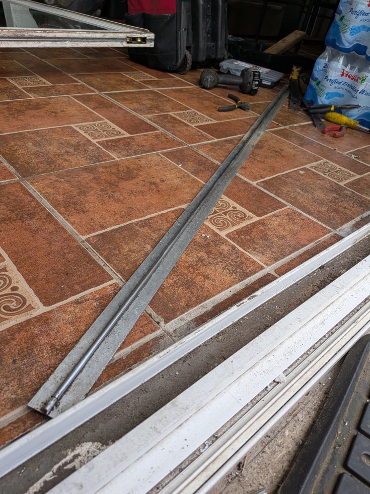 Sliding door lower track work area with the panel removed
